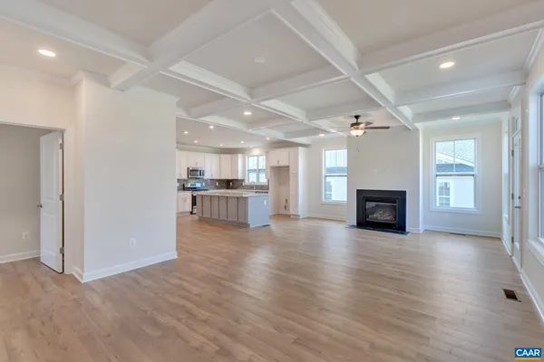 a view of kitchen and hall with wooden floor