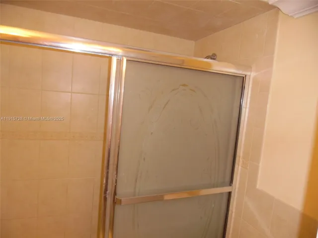 a bathroom with a glass shower door