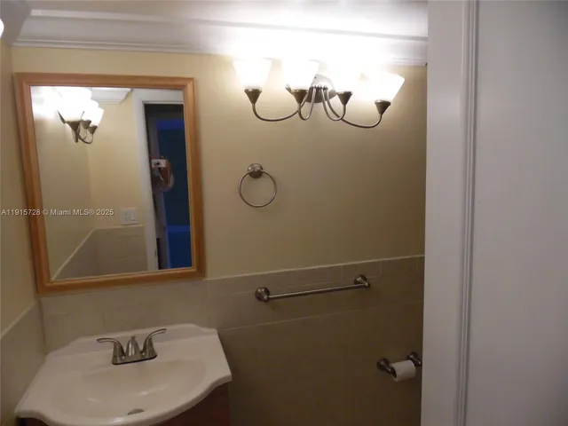 a bathroom with a sink and mirror