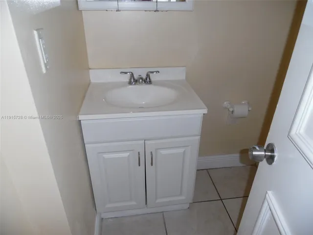 a bathroom with a sink and vanity