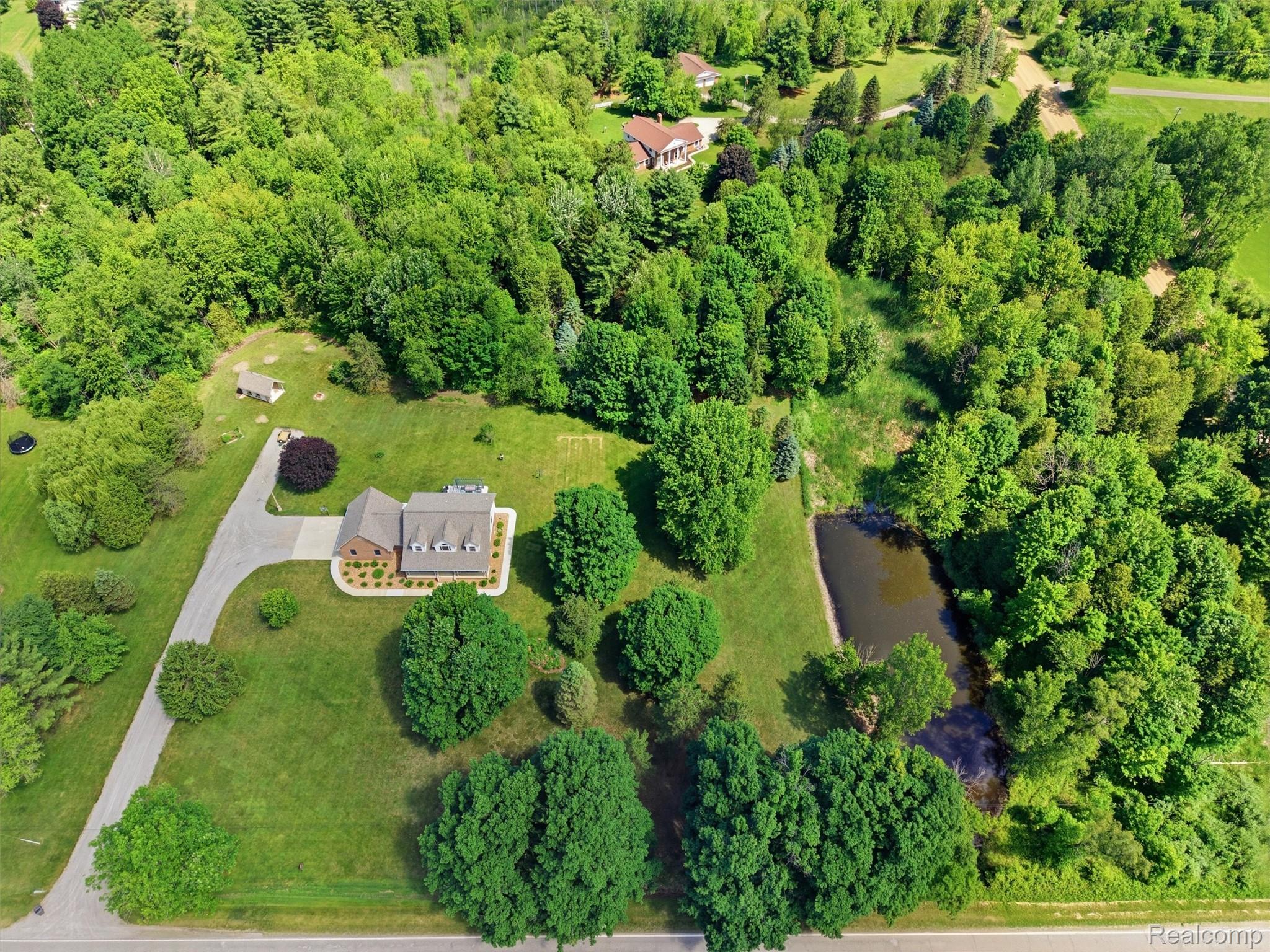 5449 Lum Road Attica, MI 48412 - Photo 11 of 82 Aerial perspective showcasing a property featuring a brick-sided residence with multiple dormer windows