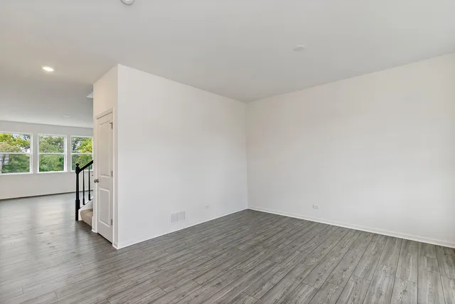 a view of a room with wooden floor and window