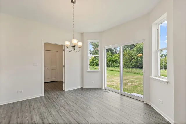 a view of a room with wooden floor and outdoor space