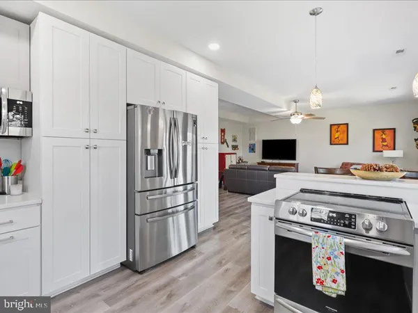 a kitchen with stainless steel appliances a stove a refrigerator and a sink