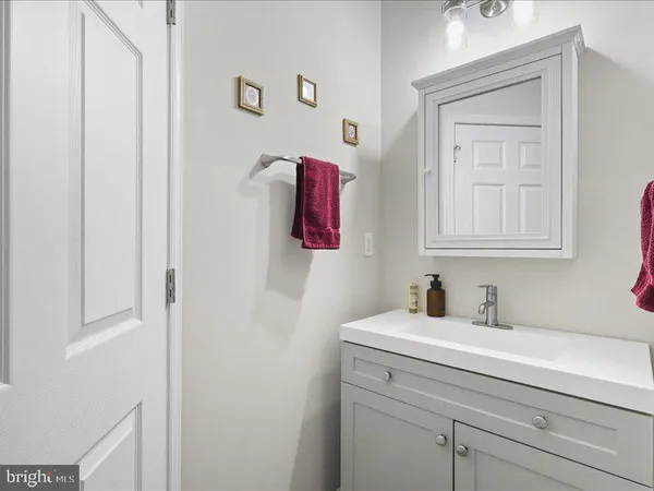 a bathroom with a sink vanity and mirror