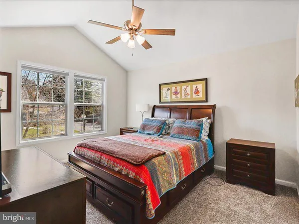 a bedroom with a bed dresser and a window