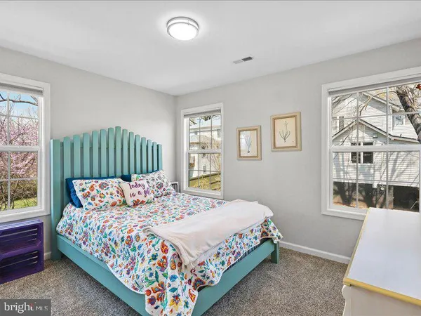 a bedroom with a bed window and a couch