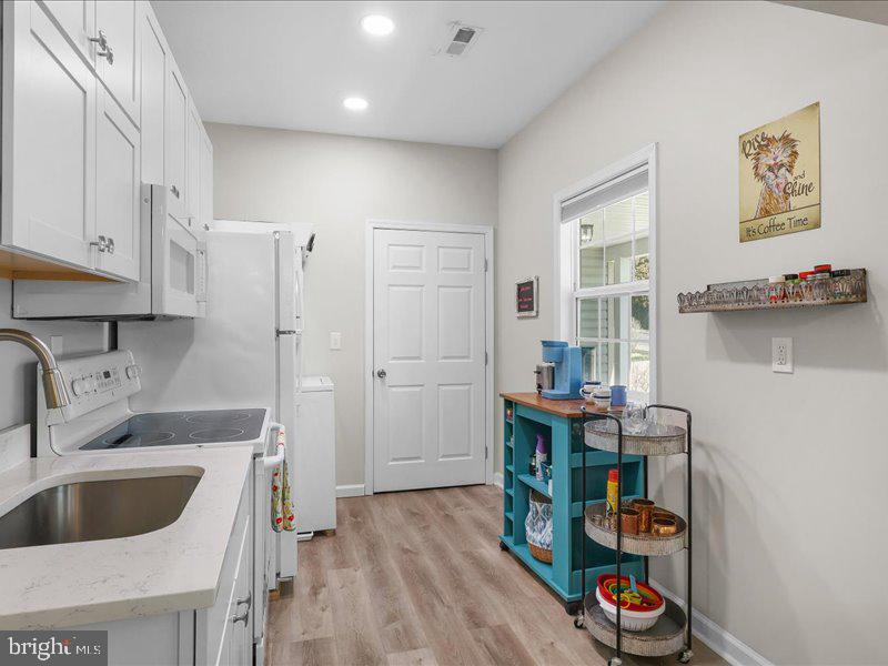 712 South Blue Ridge Avenue Culpeper, VA 22701 - Photo 31 of 47 a kitchen with stainless steel appliances a sink cabinets and wooden floor