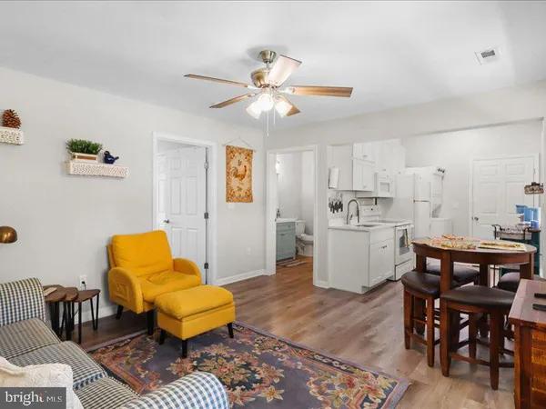 a living room with furniture and kitchen view