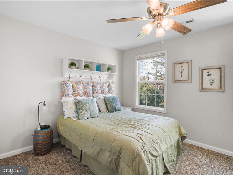 712 South Blue Ridge Avenue Culpeper, VA 22701 - Photo 36 of 47 a bedroom with a bed and a chandelier