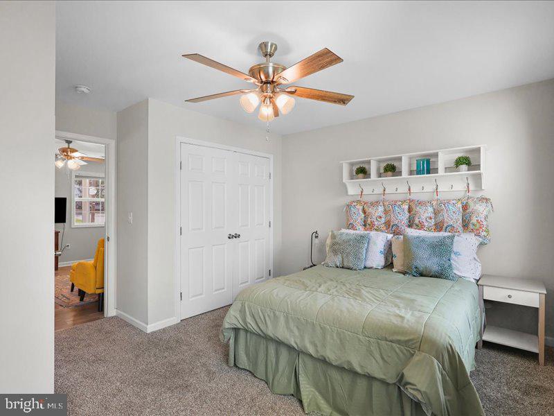 712 South Blue Ridge Avenue Culpeper, VA 22701 - Photo 37 of 47 a bedroom with a large bed and a chandelier