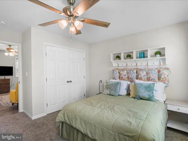 a bedroom with a bed and a ceiling fan