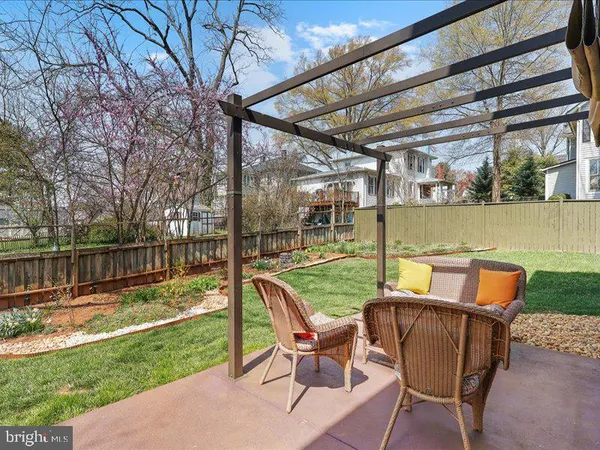a view of a chairs and table in patio with a yard