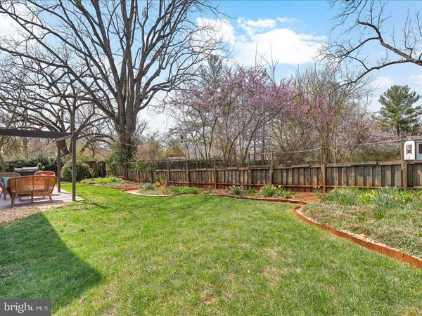 a view of a garden with wooden fence