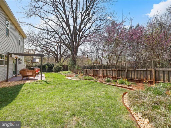 a view of a backyard with table and chairs and a slide