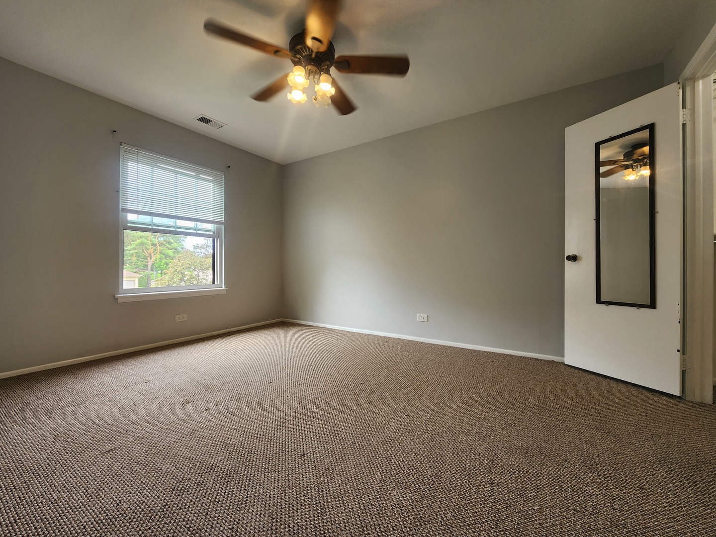1020 Boxwood Court, Unit C2 Wheeling, IL 60090 - Photo 12 of 21 an empty room with windows and fan