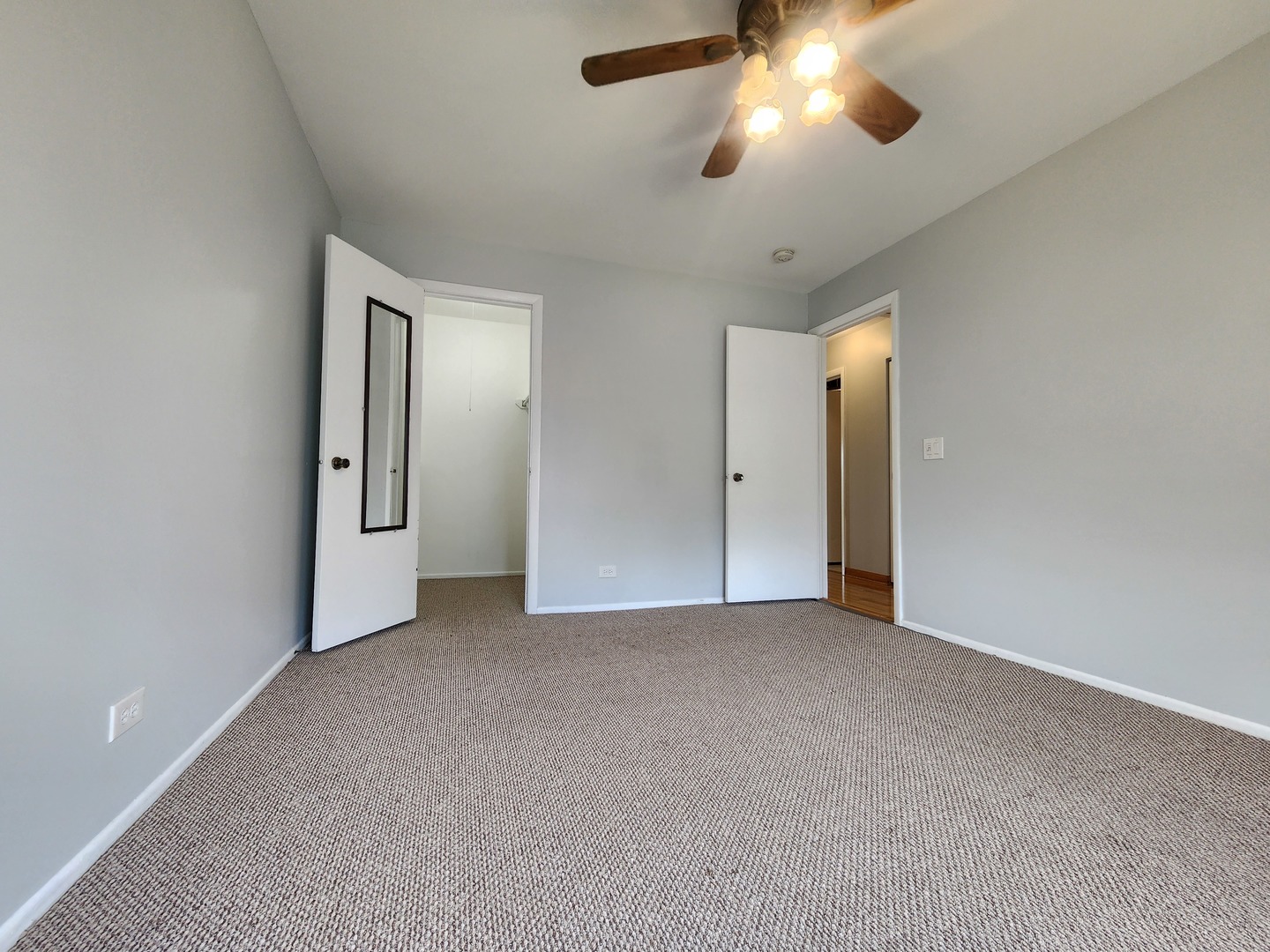 1020 Boxwood Court, Unit C2 Wheeling, IL 60090 - Photo 14 of 21 an empty room with chandelier fan and windows
