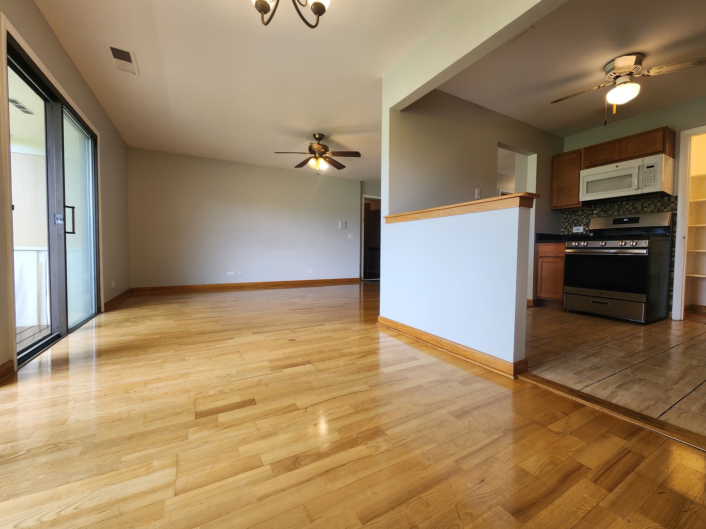1020 Boxwood Court, Unit C2 Wheeling, IL 60090 - Photo 4 of 21 a view of a kitchen with wooden floor and a ceiling fan