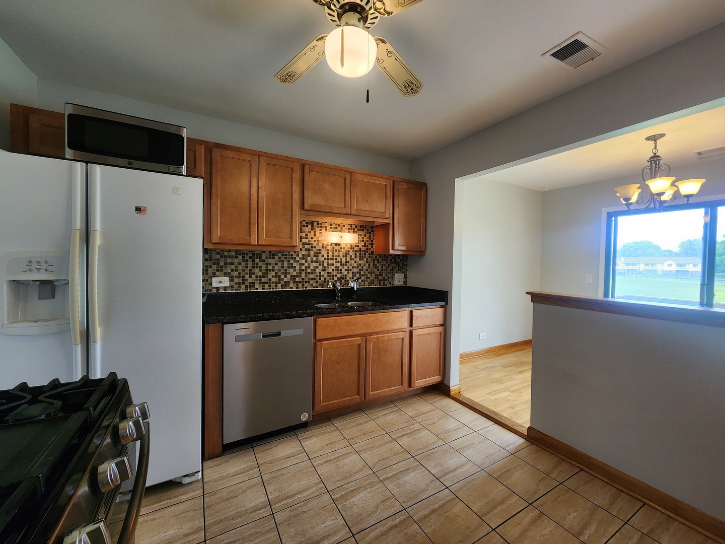 1020 Boxwood Court, Unit C2 Wheeling, IL 60090 - Photo 5 of 21 a kitchen with a refrigerator and a stove top oven