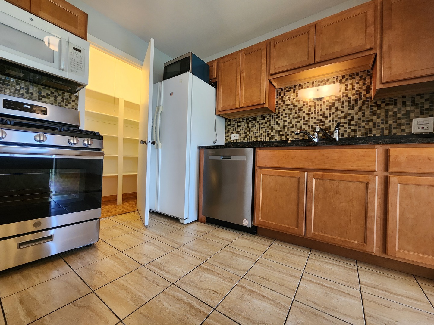 1020 Boxwood Court, Unit C2 Wheeling, IL 60090 - Photo 6 of 21 a kitchen with stainless steel appliances granite countertop a refrigerator a stove and a sink