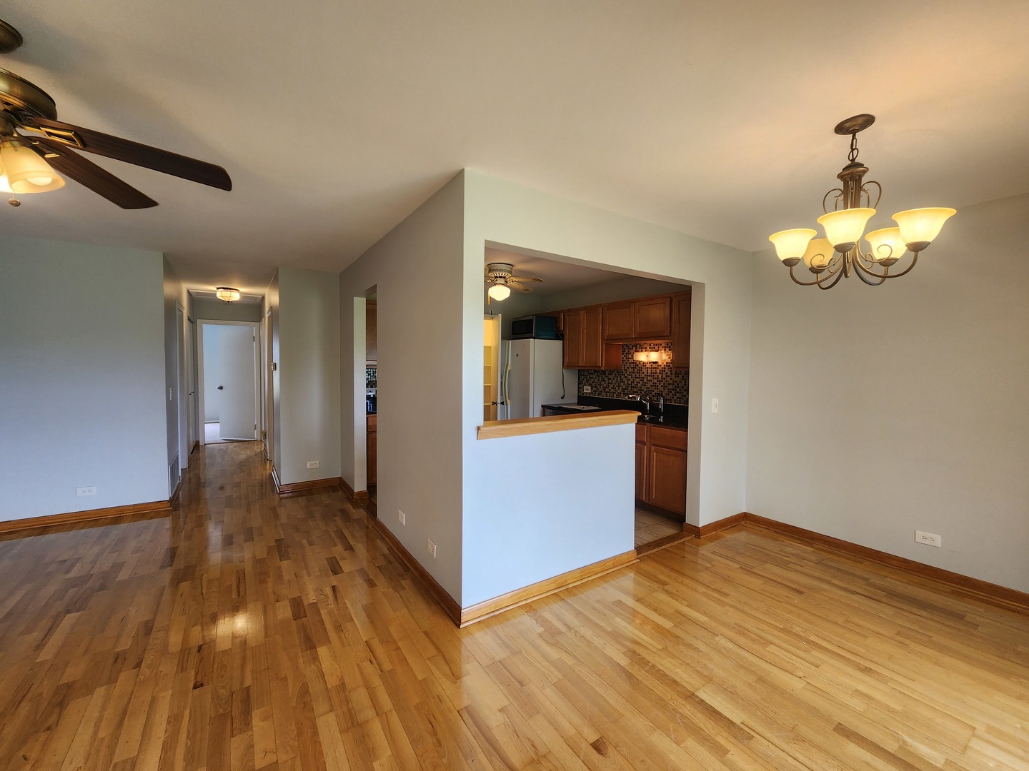 1020 Boxwood Court, Unit C2 Wheeling, IL 60090 - Photo 8 of 21 a view of a room with wooden floor and kitchen
