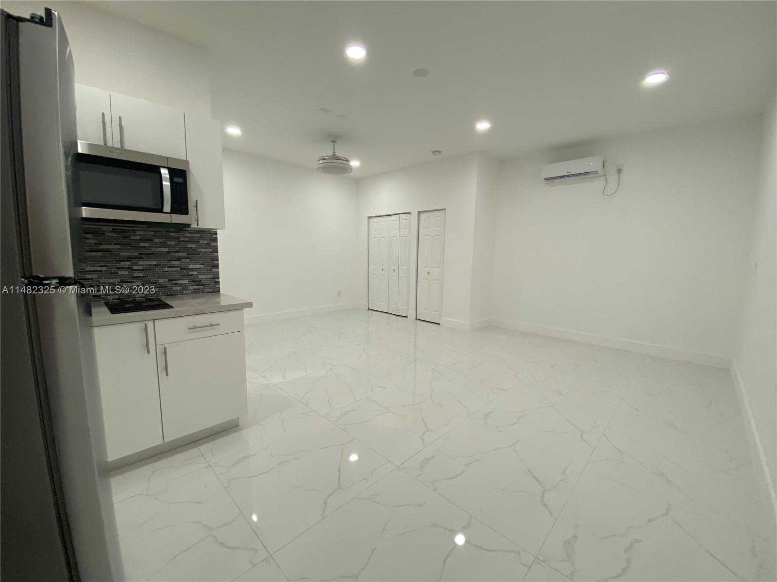 12829 Southwest 228th Street, Unit 2 Miami, FL 33170 - Photo 21 of 23 a view of a refrigerator in kitchen and white cabinets