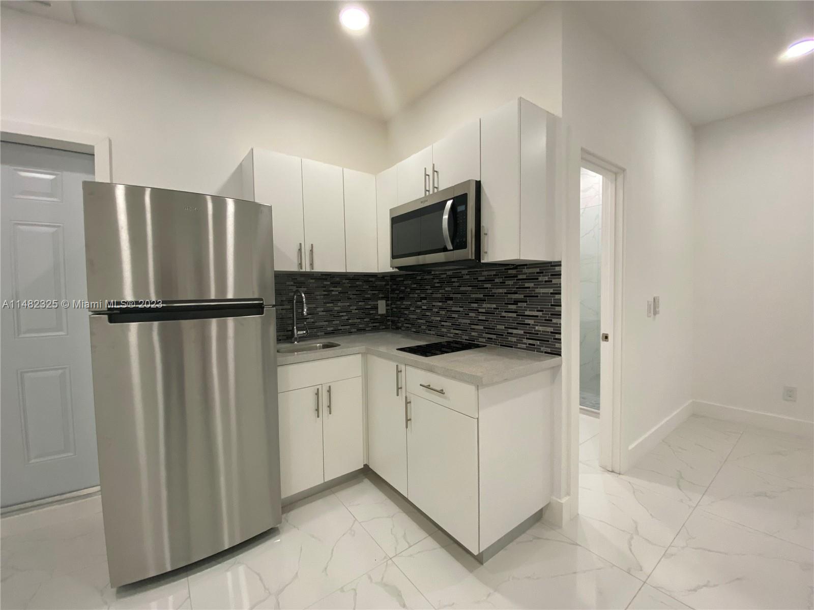 12829 Southwest 228th Street, Unit 2 Miami, FL 33170 - Photo 5 of 23 a kitchen with stainless steel appliances granite countertop a refrigerator and a sink