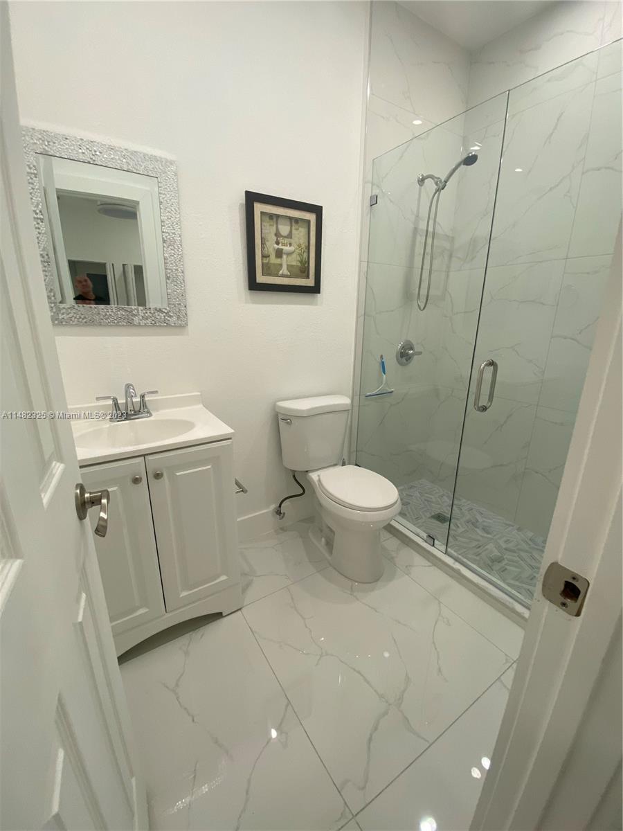 12829 Southwest 228th Street, Unit 2 Miami, FL 33170 - Photo 6 of 23 a bathroom with a sink toilet and shower