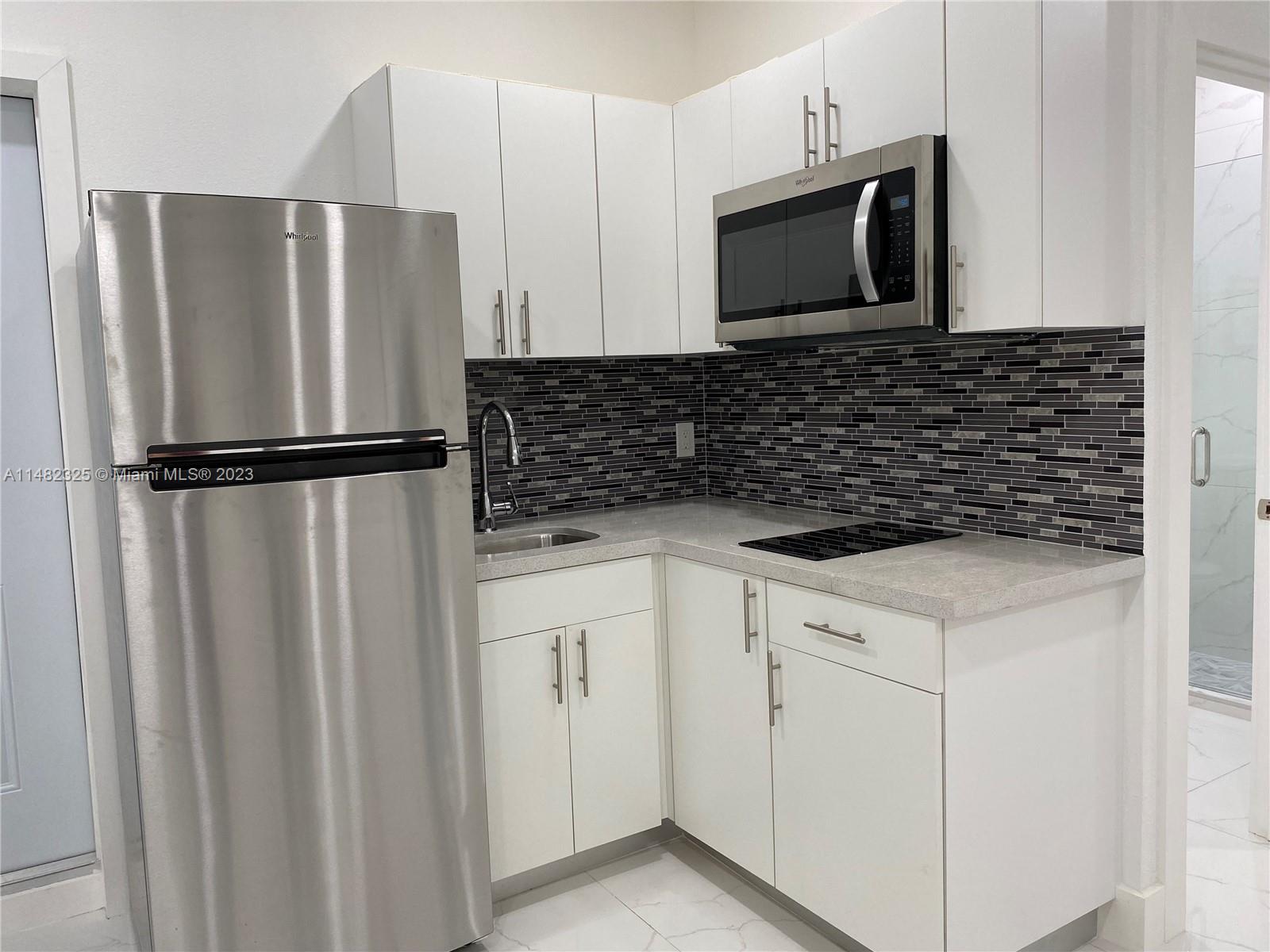 12829 Southwest 228th Street, Unit 2 Miami, FL 33170 - Photo 8 of 23 a kitchen with a refrigerator sink and microwave
