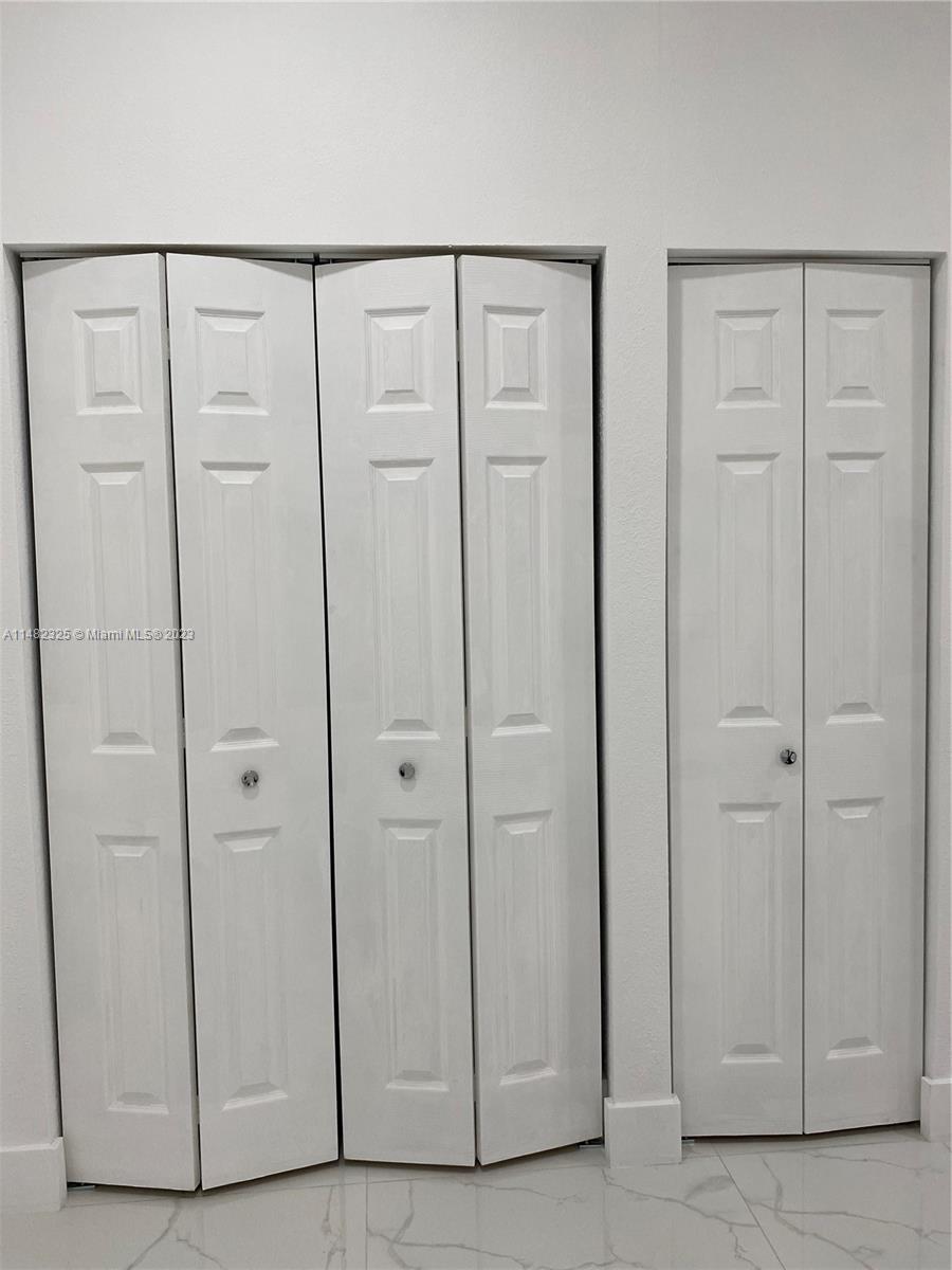 12829 Southwest 228th Street, Unit 2 Miami, FL 33170 - Photo 10 of 23 a view of a closet area with hardwood floor