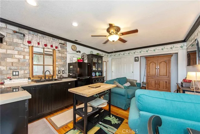 a living room with furniture a chandelier and a flat screen tv