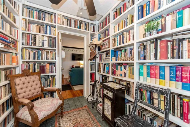 a living room with a book shelf and a book shelf