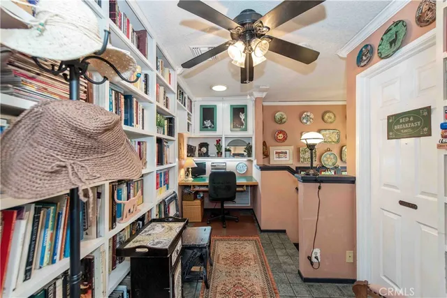 a living room with furniture and a book shelf
