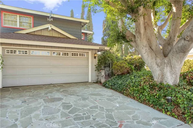 a view of a garage with a tree