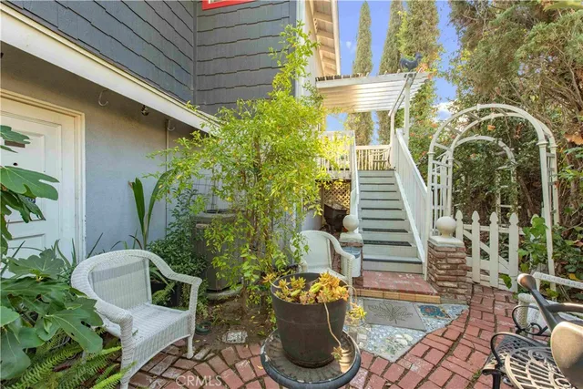 a front view of a house with outdoor seating