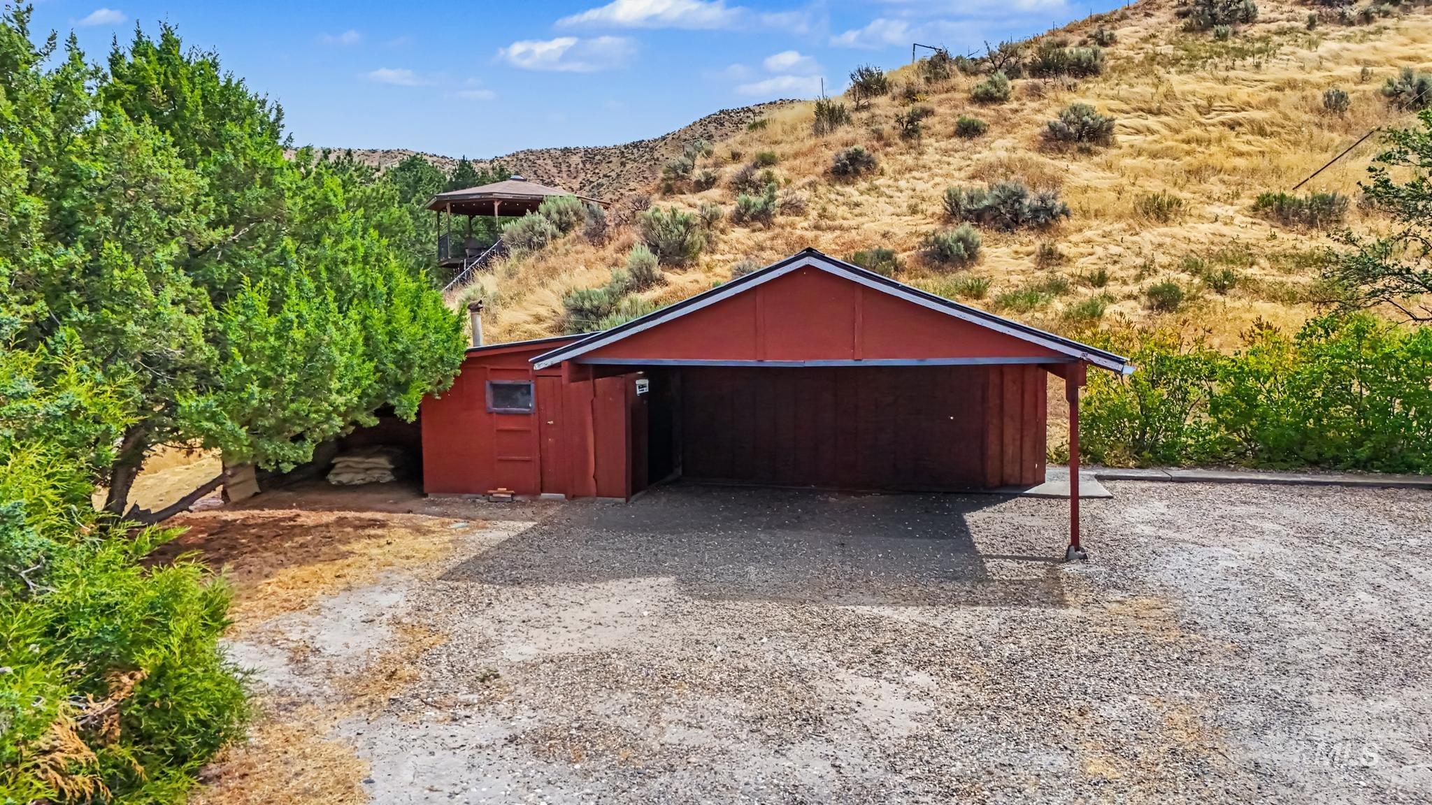 4311 Frozen Dog Road Emmett, ID 83617 - Photo 3 of 31 Red-sided outbuilding featuring an integrated carport with a gravel parking area