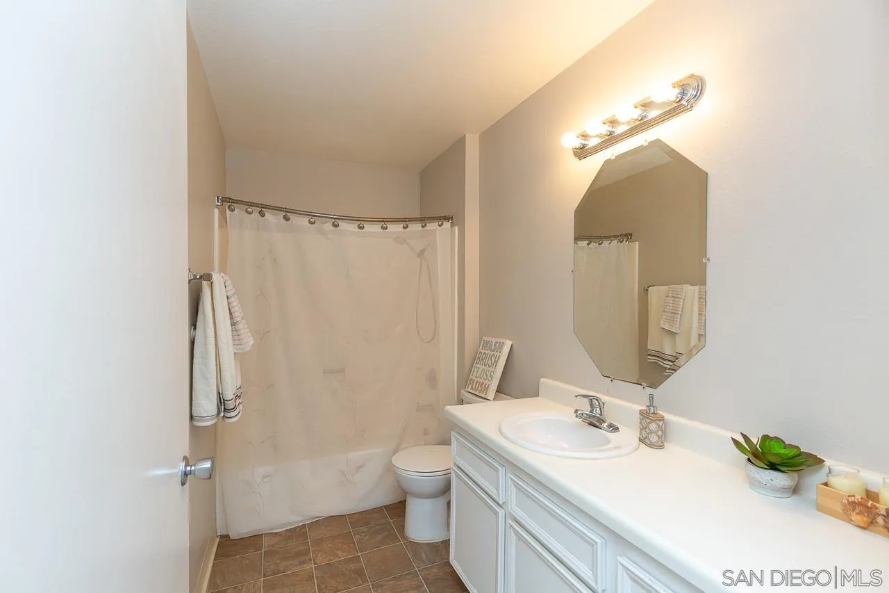 6171 Rancho Mission Road, Unit 208 San Diego, CA 92108 - Photo 9 of 18 a bathroom with a sink a toilet and shower