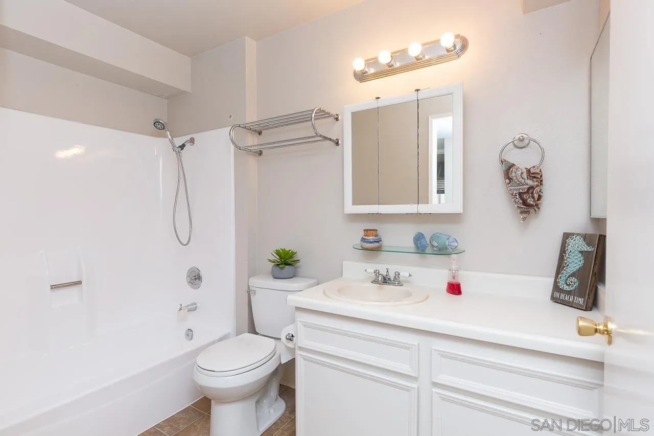 6171 Rancho Mission Road, Unit 208 San Diego, CA 92108 - Photo 10 of 18 a bathroom with a sink toilet and shower