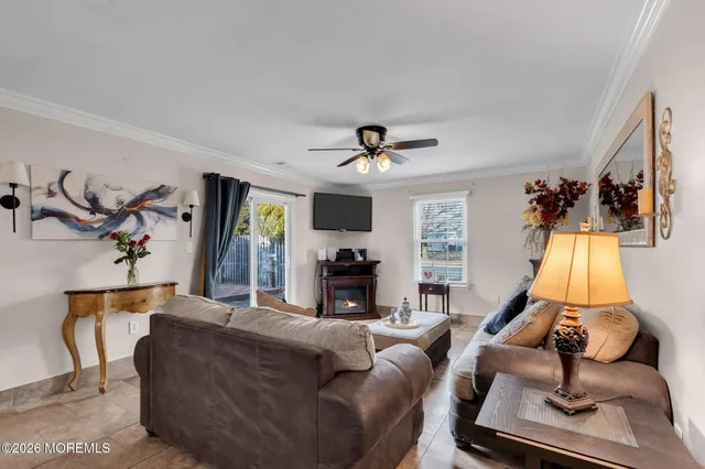 a living room with furniture gym equipment and a fireplace