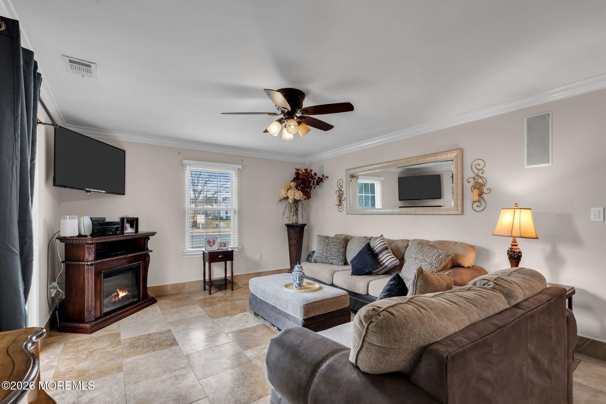 1 Breakwater Square Freehold, NJ 07728 - Photo 12 of 33 a living room with furniture a ceiling fan and a flat screen tv