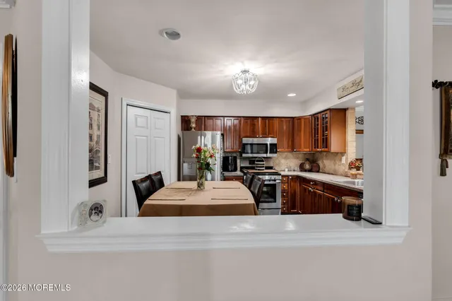 a large kitchen with a large counter top appliances and cabinets