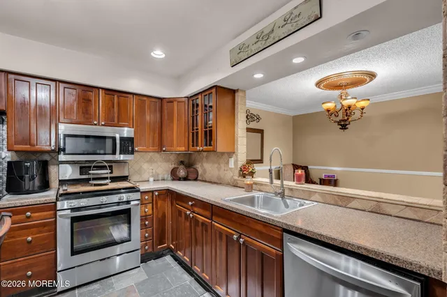 a kitchen with a sink appliances and cabinets