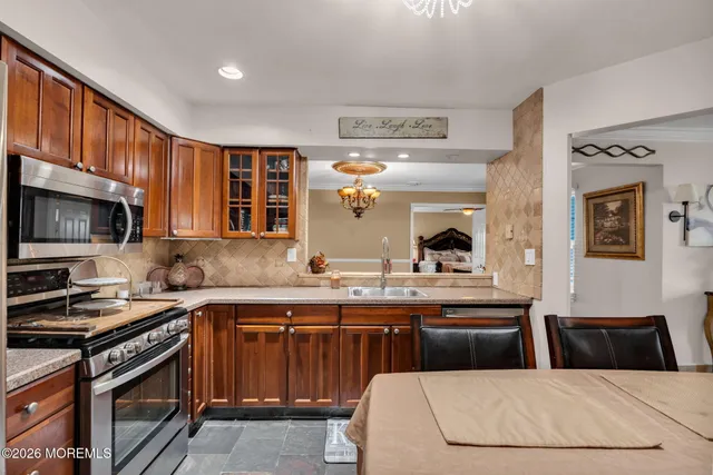 a kitchen with a sink a stove and cabinets
