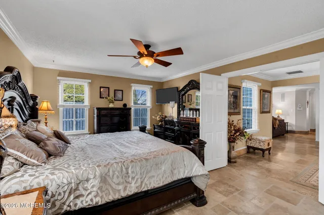 a bedroom with a bed gym equipment and a large window