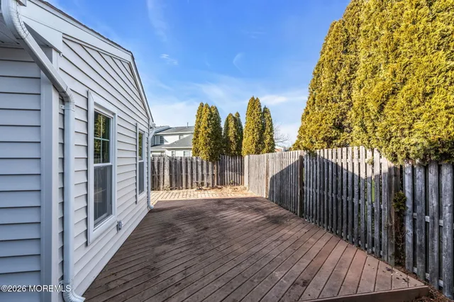 a view of a balcony with wooden floor and fence