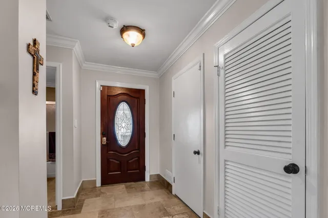 a view of a hallway with entryway door