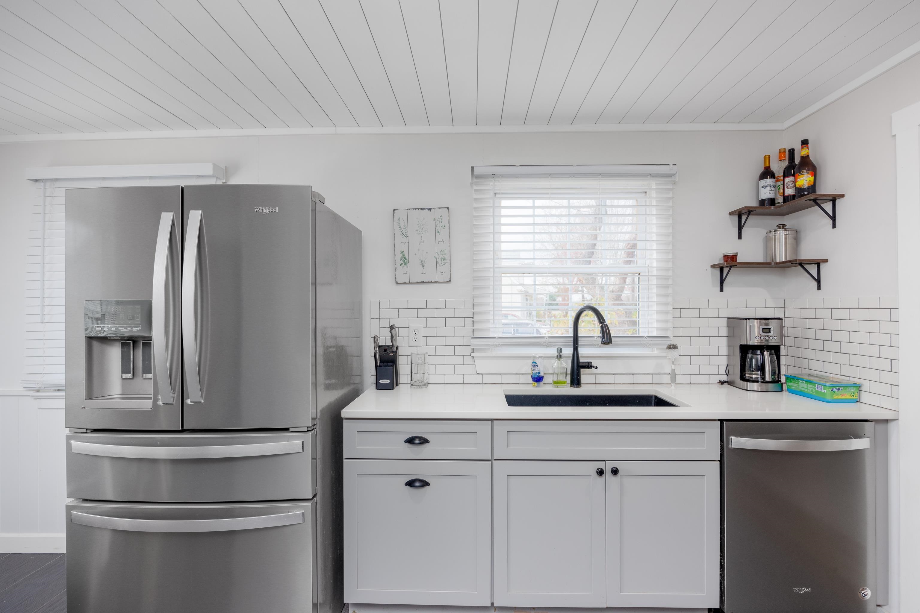 103 Bate Avenue Rio Grande, NJ 08242 - Photo 14 of 50 a kitchen with stainless steel appliances a refrigerator sink and cabinets