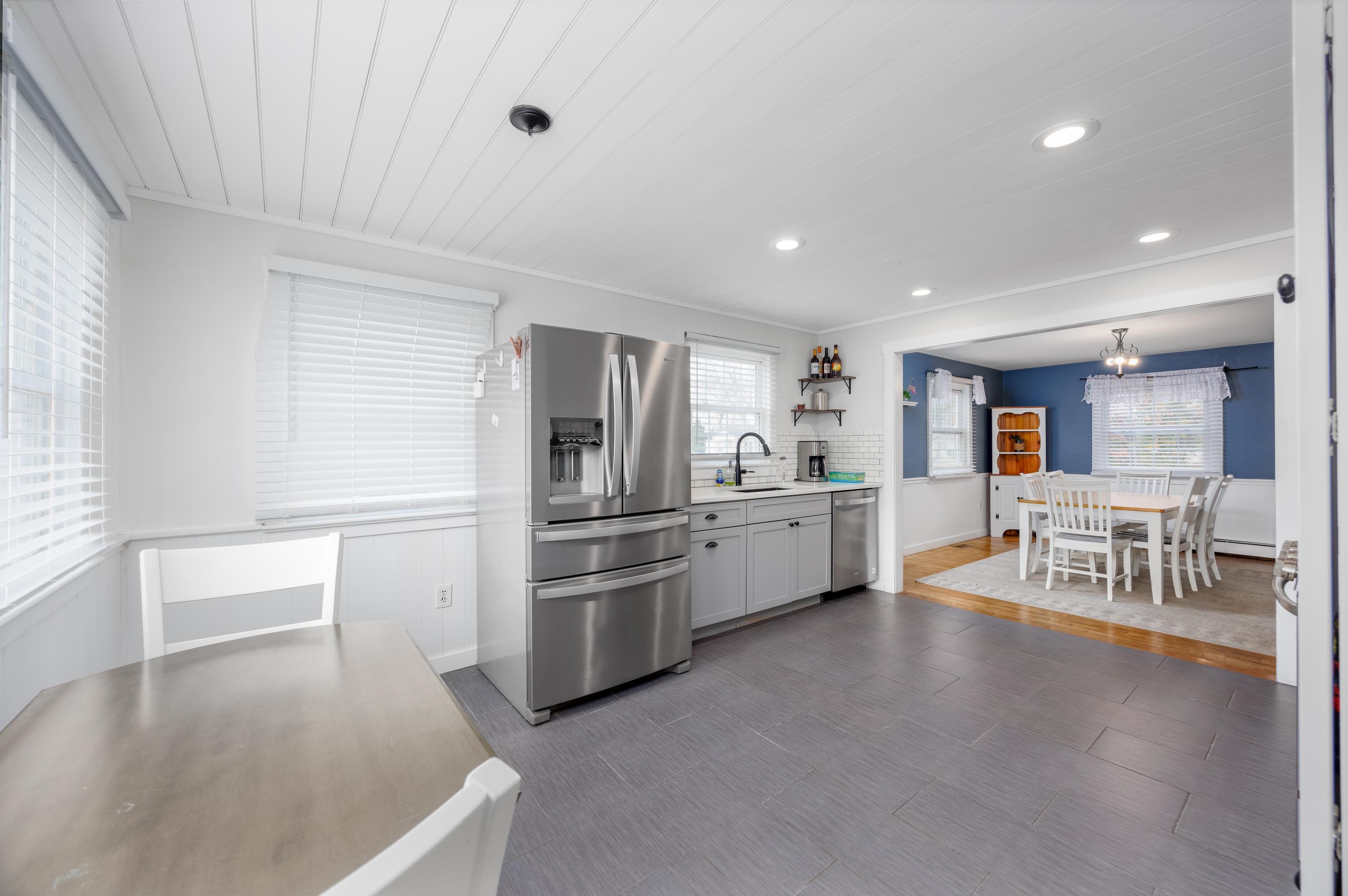 103 Bate Avenue Rio Grande, NJ 08242 - Photo 15 of 50 a kitchen with stainless steel appliances kitchen island granite countertop a refrigerator and a stove top oven
