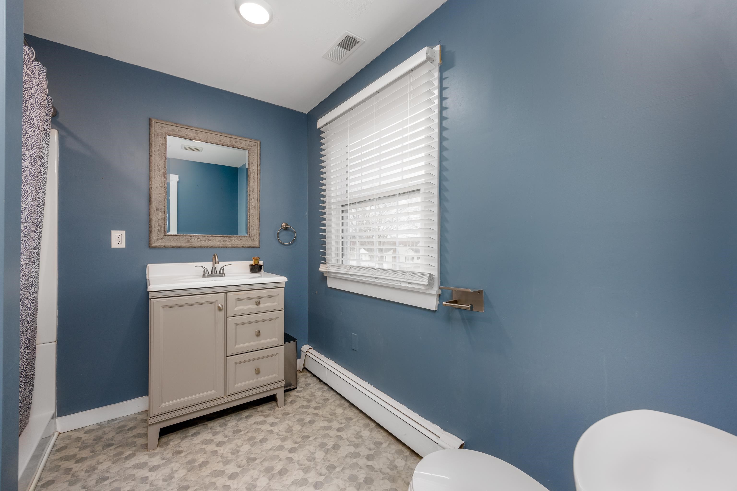 103 Bate Avenue Rio Grande, NJ 08242 - Photo 24 of 50 a bathroom with a toilet sink and mirror