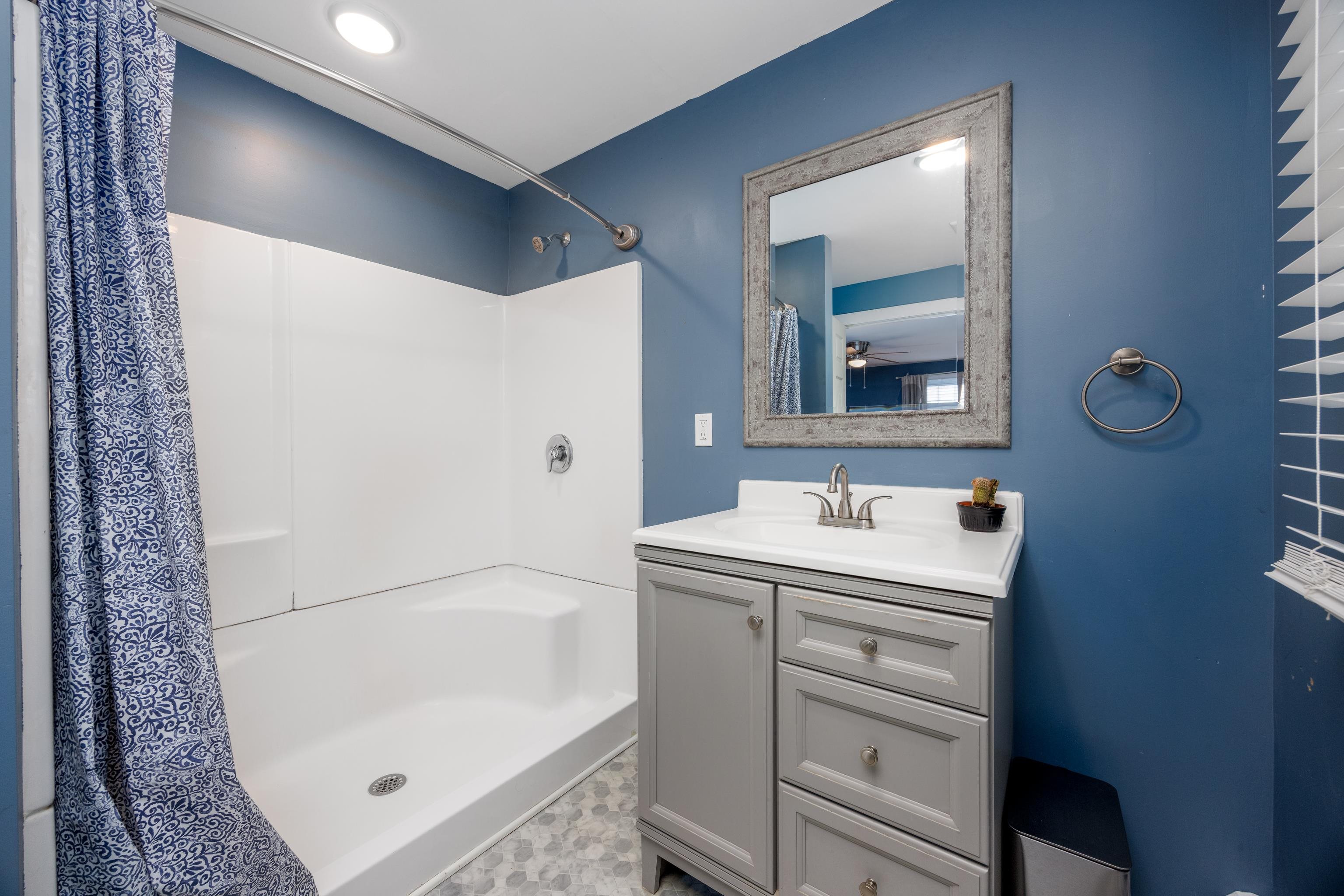 103 Bate Avenue Rio Grande, NJ 08242 - Photo 25 of 50 a bathroom with a bathtub sink vanity and mirror